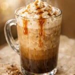 Creamy Big Train mocha blended ice coffee in a tall glass with whipped cream and chocolate drizzle.