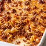 Golden, bubbly ground beef casserole with melted cheese in a baking dish