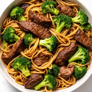 Stir-frying beef and broccoli in a hot wok for quick Simple Beef and Broccoli Lo Mein, glossy sauce coating tender noodles.