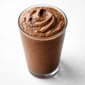 Blending a creamy mocha iced coffee with chocolate syrup and ice cubes for a rich, smooth drink