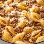Creamy beef and shells in a white bowl, with a rich tomato-cream sauce coating the pasta and sprinkled with fresh parsley.