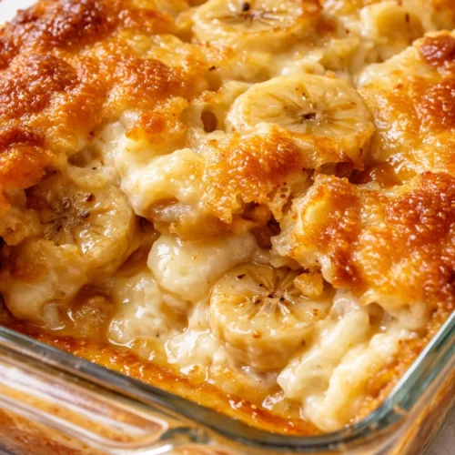 Golden buttery crust topping warm gooey banana cream cheese cobbler with creamy filling