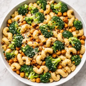 Steaming broccoli and chickpea pasta in a one-pot sauce, with tender florets and creamy texture.