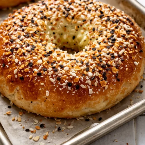 Golden brown cottage cheese flagels with a soft, chewy texture, topped with sesame seeds and poppy seeds.