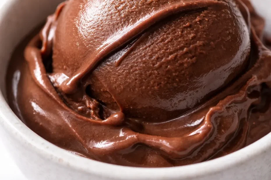 Smooth, dangerously dark chocolate gelato with a silky, slow-melt texture and glossy surface in a glass bowl.