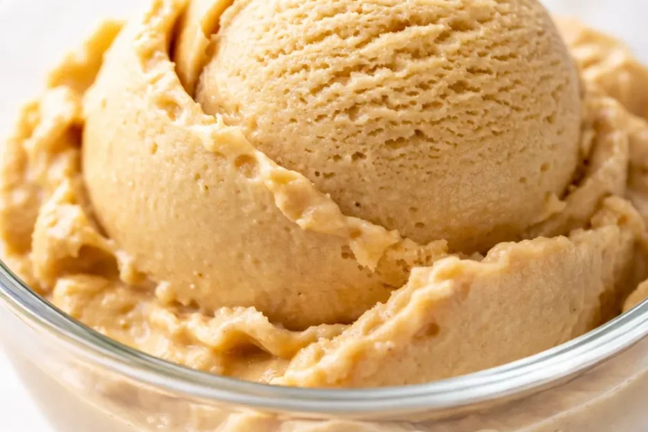 Scoop of creamy homemade coffee ice cream with rich brown color and smooth texture in a chilled glass bowl.