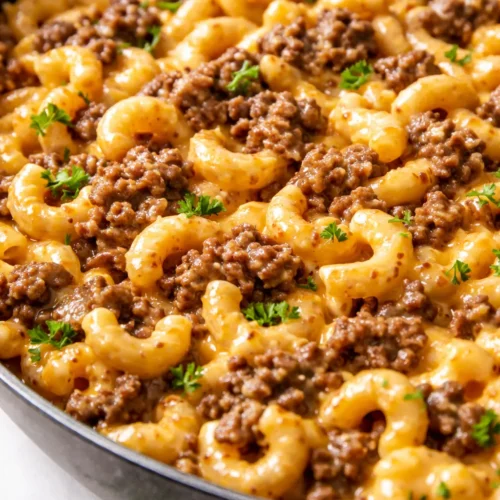 Creamy one-pan cheeseburger macaroni with melted cheddar, seasoned ground beef, and tender elbow pasta in a rich, savory sauce.