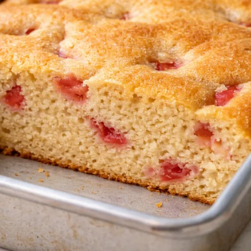 Moist buttermilk strawberry shortcake sheet cake with fresh strawberries and whipped cream