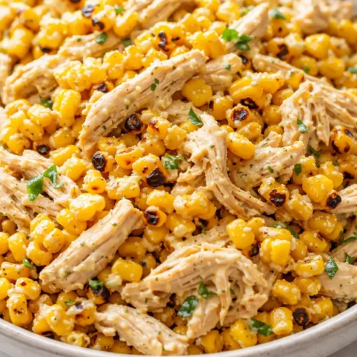 Street corn chicken salad with charred corn, shredded chicken, crisp cucumber, creamy lime dressing, and cotija.